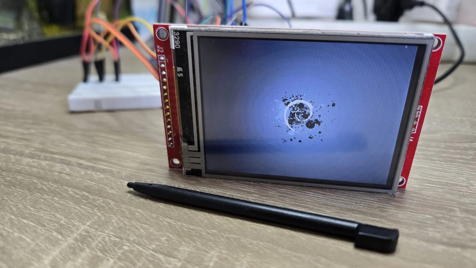 A dark blue picture with ink splashes in the middle, on the LCD