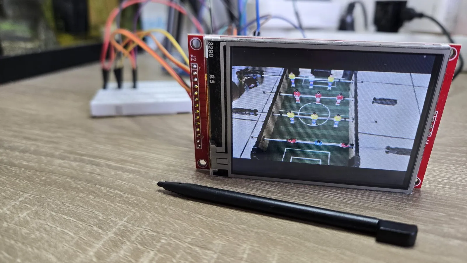 A photo of a table football game on the LCD